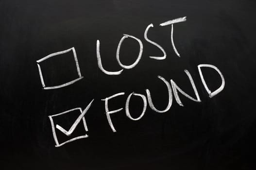 Lost and found check boxes written with chalk on a blackboard