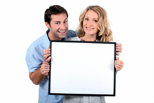 Couple holding white board