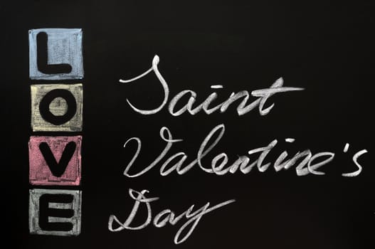 Love with Saint Valentine's Day drawn in colorful chalk on a chalkboard 