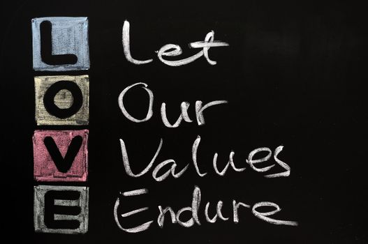 LOVE acronym, Let our values endure on a blackboard with words written in chalk