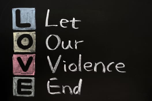 LOVE acronym, Let our violence end on a blackboard with words written in chalk