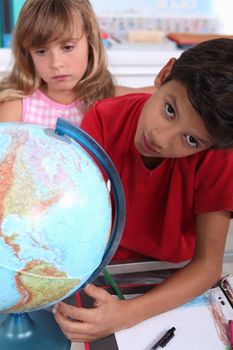 Children at school with a globe