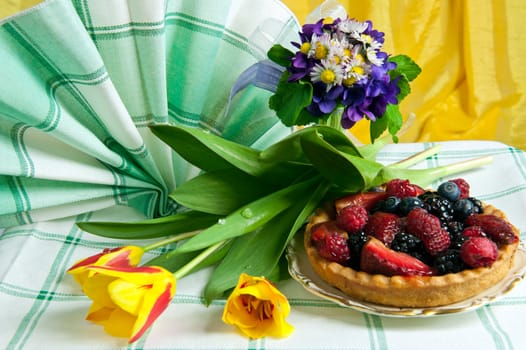 Two cakes with berries on white background