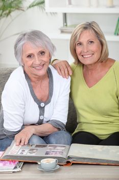 duo of mature women skimming through album