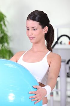 young woman doing Swiss ball exercises