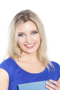Smiling female holding blue book in a close up portrait