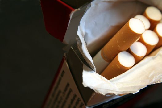 A macro shot of pack of cigarettes, shot with a very shallow depth of field.
