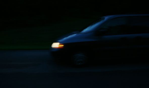 A van shot at night moving quickly. (motion blur)