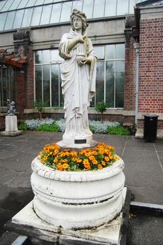Old statue with flowers, Auckland Domain, New Zealand