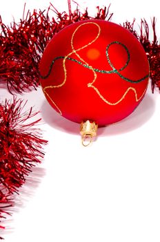 Red christmas toy with glossy ornaments isolated on white background with shadow.