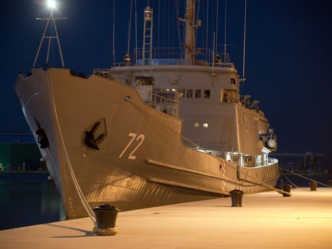 military ship anchored in winter night