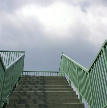Concrete stairs and green railing