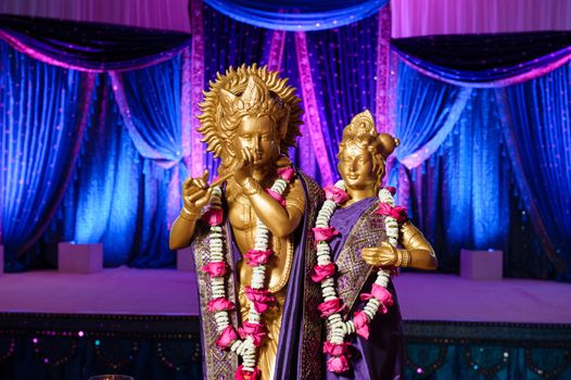 Image of Hindu Deities in front of mandap at Indian wedding