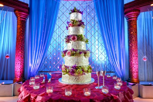 Image of a tall tiered wedding cake at Indian wedding