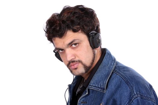 An Indian Guy listening to music on headphones, on white studio background.