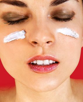 Skin care woman putting face cream touching under eyes