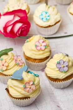 a group of decorated Cupcakes with pink rose