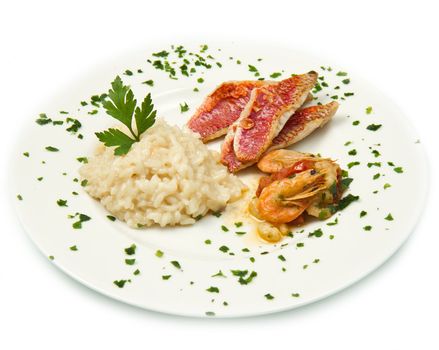 white dish with rice , red mullet fillets and seafood
