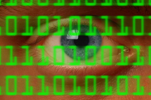 Close-up of eyeball watching digital binary code