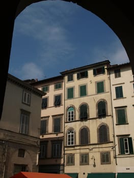 View from piazza Anfiteatro, former a Roman Ampitheatre, in Lucca. Tuscany, Italy. This square was built on the fundations of a Roman amphiteater built in the second half of the first century a. D. Later it became a quarry to supply the town with materials for churches and palaces. Several buldings were constructed inside this oval area in the Middle Ages