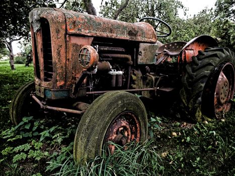 Old rusty red vintage tractor in a farm digital art manipulated