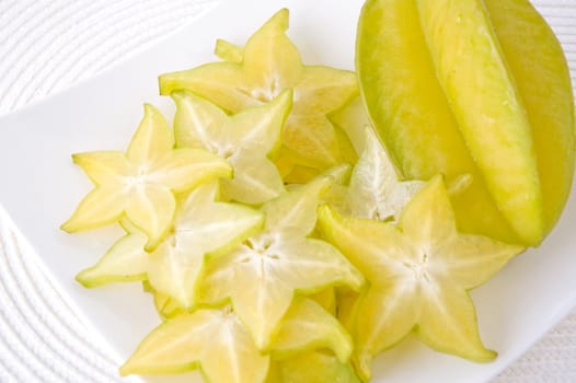 sliced carambola on white plate