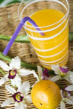 close up glass of fresh orange juice with drinking straw