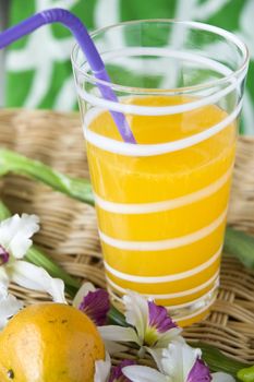 glass of fresh orange juice with colorful background