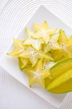 sliced fresh starfruit serve on white plate