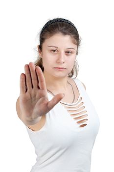 young brunette girl with brown eyes is showing the stop gesture on white background