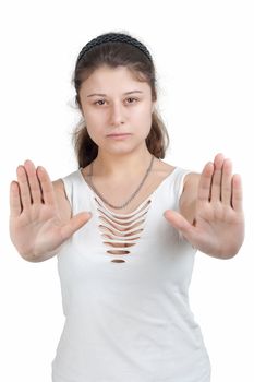 young brunette girl with brown eyes is showing the stop gesture on white background