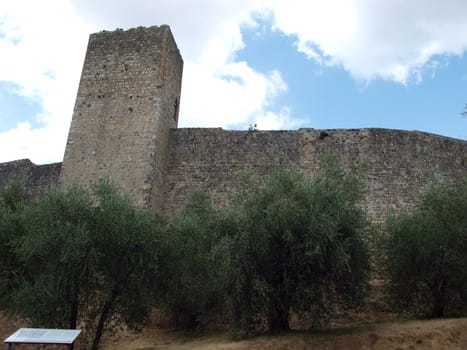 Town-walls of Monteriggioni, medieval village completely encircled from circular walls with 14 towers. Siena, Tuscany, Italy
