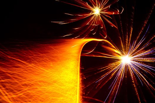 Two starbursts taking off with colorful sparkle