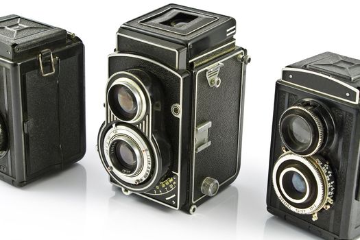 Three Vintage two lens photo camera isolated on white