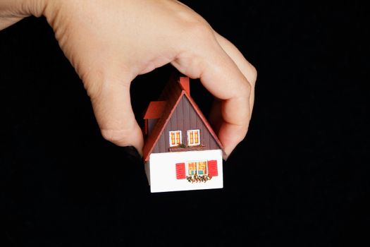 Image of house with red roof in hand
