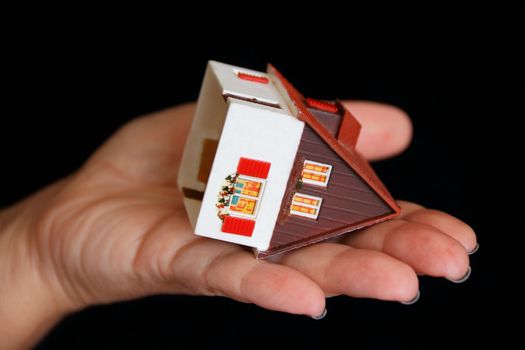Image of house with red roof in hand