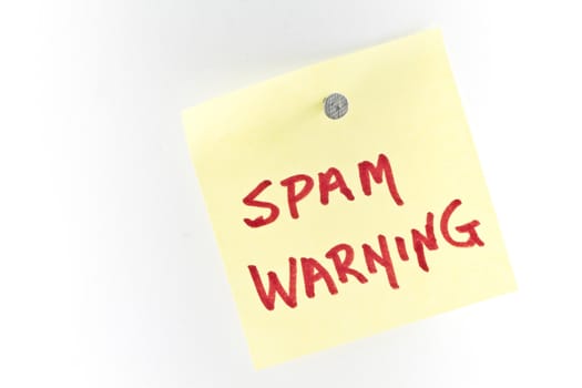 Warning note with with Spam Warning lettered on it is nailed up as modern remiinder