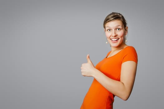 An image of a young woman with a thumb up