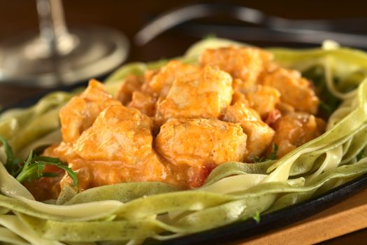 Fish goulash made of diamond dogfish prepared in Hungarian-style with pasta (Selective Focus, Focus on the fish piece in the front)