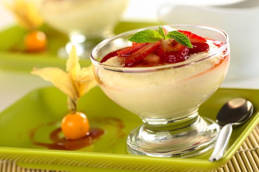 Semolina pudding with strawberry, strawberry sauce and mint leaf (Selective Focus, Focus on the front of the mint leaf)