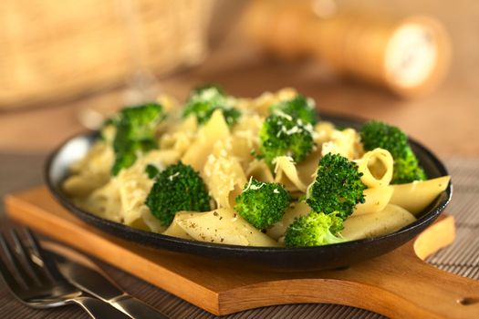 Broccoli and pasta baked with grated cheese (Selective Focus, Focus on the two broccoli florets one third into the image)