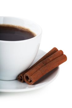 Cup of coffee and cinnamon over white background