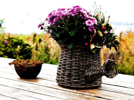 Beautiful still life basket of flowers on a wooden table digital art manipulated