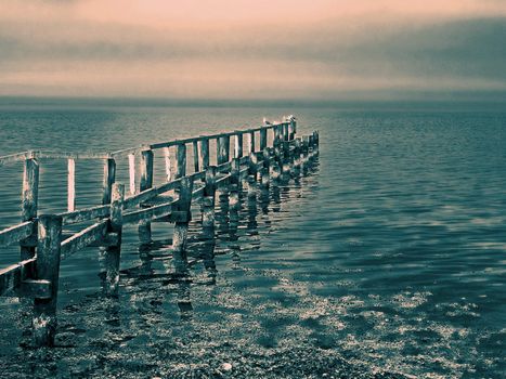 Beautiful seascape of a wooden footbridge in the middle of nowhere digital art manipulation