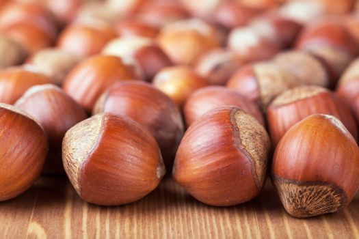 Closeup view of hazelnuts on a wooden table