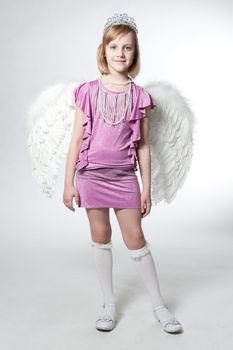 little princess in purple dress and wings isolated on white