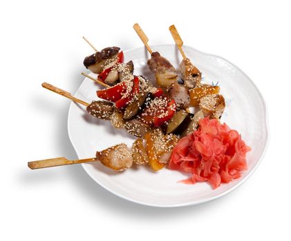 Meat skewers on a plate isolated on white background