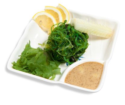Salad with marinated seaweed isolated on white background