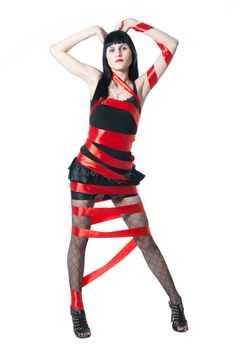 Sexy women in black dress rolled up by a red ribbon