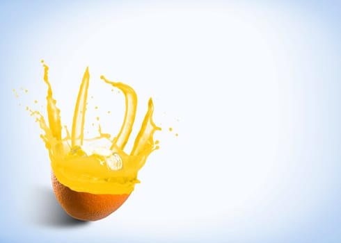 ice cubes fall into the orange, spray and splashes of juice